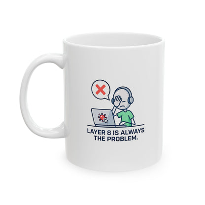 White mug with 'layer 8 is always the problem' logo on a wooden surface