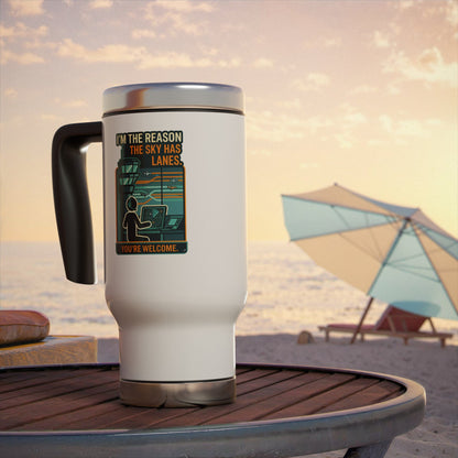 White travel mug with a graphic design on a beach table with an umbrella in the background