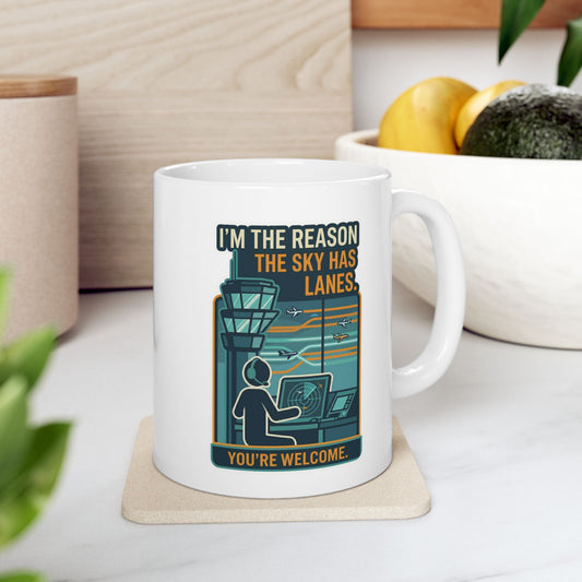 Mug with aviation-themed design on a coaster, placed on a surface with a plant and container in the background.