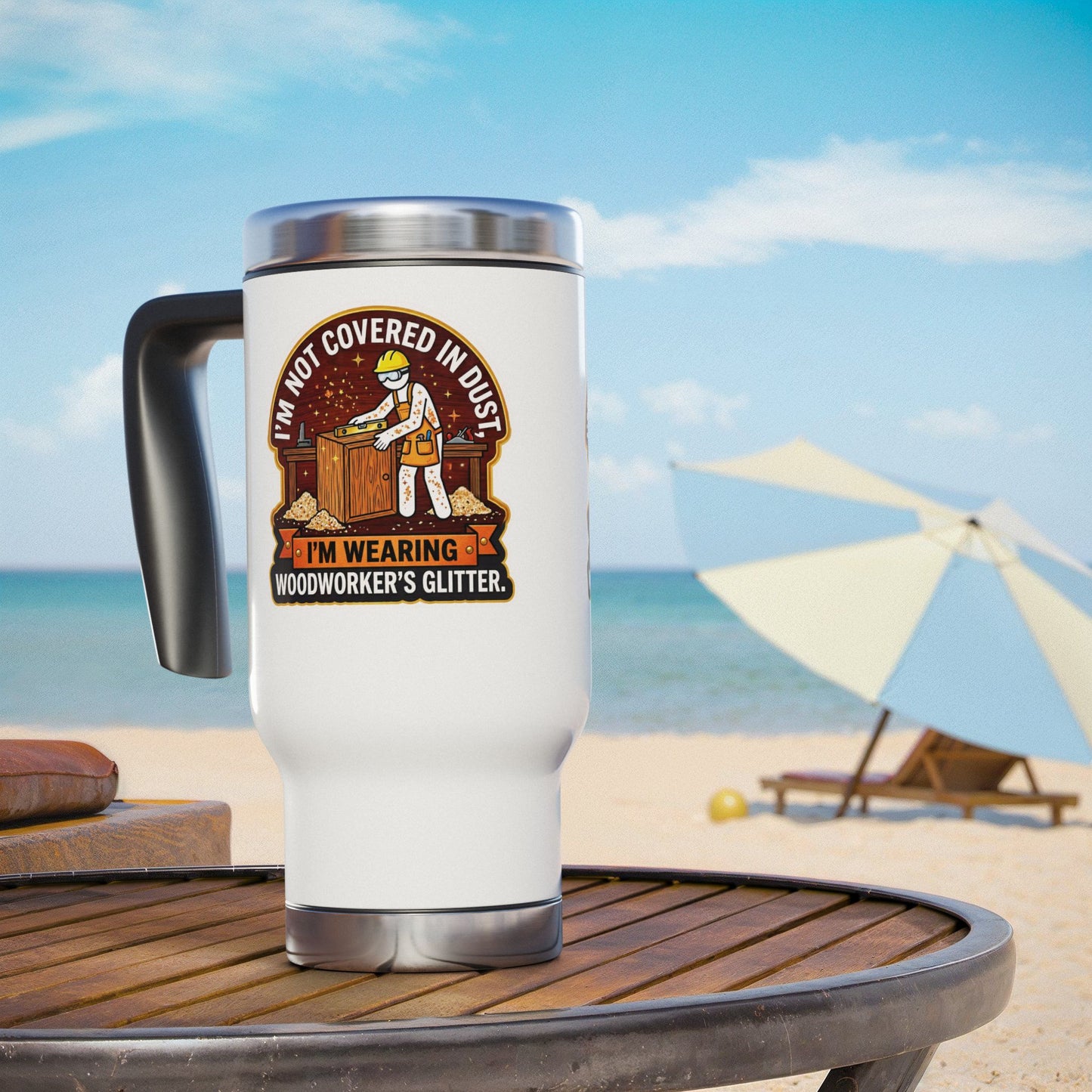 White travel mug with a graphic design on a beach table with ocean and umbrella in the background