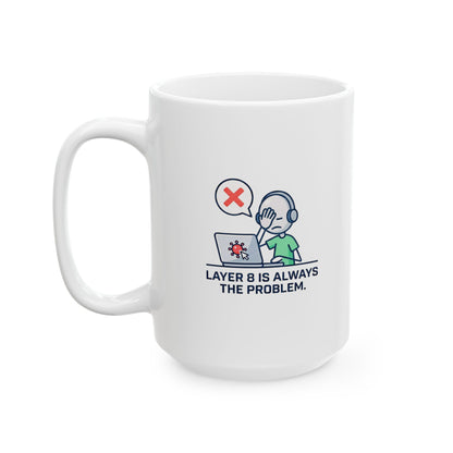White mug with 'layer 8 is always the problem' logo on a wooden surface