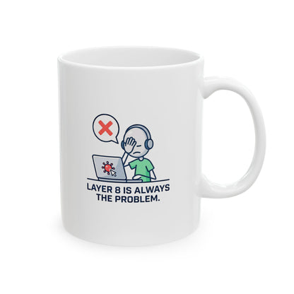 White mug with 'layer 8 is always the problem' logo on a wooden surface